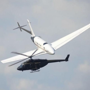 an normal white coloured aeroplane and an black army helicopter Mid-Air Collision